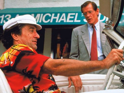 Robert De Niro is sat in a car talking to Nick Nolte next to the car.