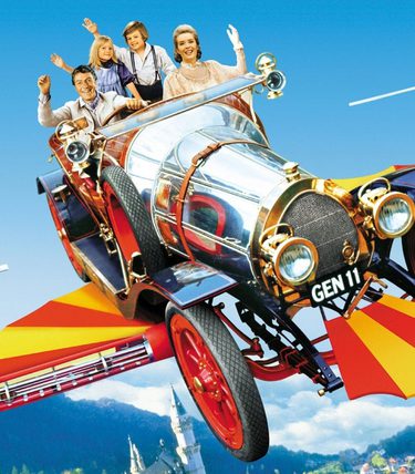 A family are sat in a flying car against a blue sky and mountain backdrop.