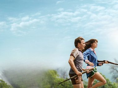 Anne Hathaway an d Ewan McGregor are running away from a dinosaur.