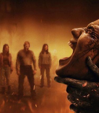 A womans face is on the right, she is being grabbed by a burnt hand and screaming. There are background charcters out of focus in fire.