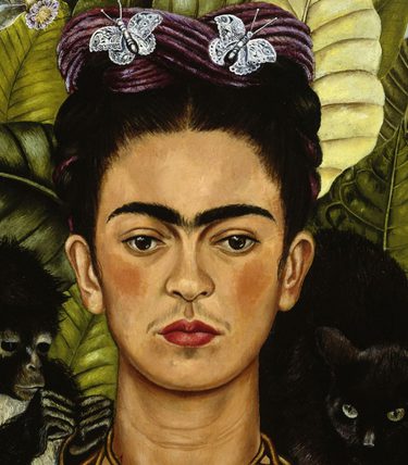 Self portrait of artist Frida Kahlo. She is surrounded by green leaves and animals.