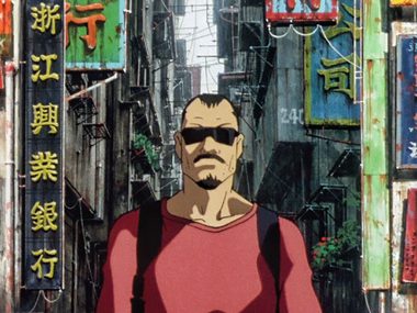 Anime image. A man with sunglasses isstood against a busy city with multiple signs behind him.