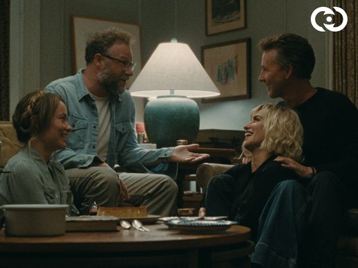 Two couples are sat at a table chatting and look friendly.