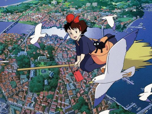 A young witch is flying on a brromstick over a town. She has a cat and is flying alongside birds.