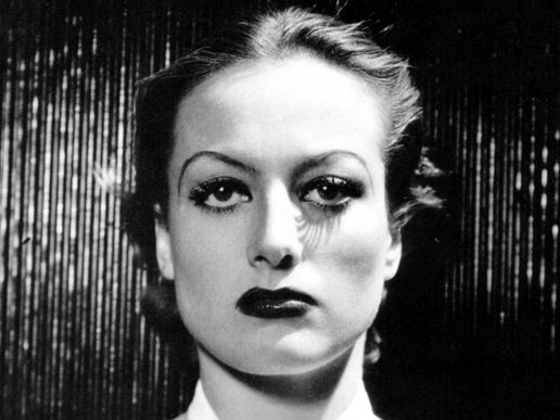 Black and White image of a womans face in very stark make-up.