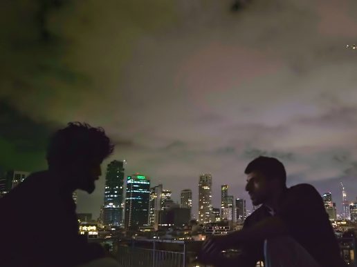 A man is silhouetted againts a dark night.