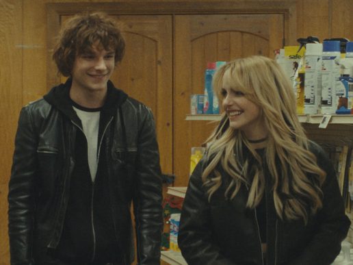 A young man and woman are in a grocery store. They look 90s rock and roll.