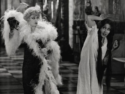 Black and white image of a well to do woman about to strike another woman.
