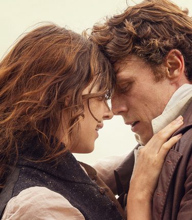 A man and woman are close together about to embrace.