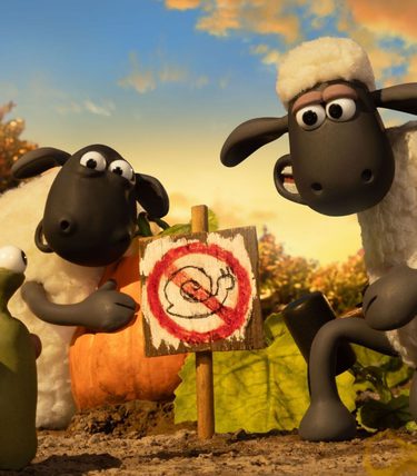 Shaun the Sheep and a sheep pal are showing a snail a 'No Snails' sign.