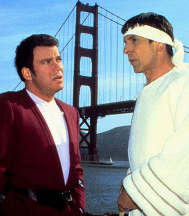 Captain Kirk and Spock are talking in front of the Golden Gate Bridge.
