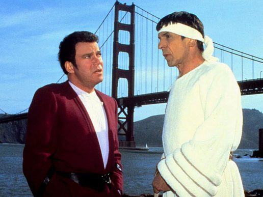 Captain Kirk and Spock are talking in front of the Golden Gate Bridge.