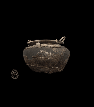 This rare bronze cauldron was found in 1946, along with numerous copper-alloy axe heads, a shield boss and fragments of at least one other cauldron. It is an example of very fine metalworking techniques, and the display of power in a period of transition when the use of iron began to spread. Almost certainly made in Ireland, the cauldron would have been used by the owner to display power and status during feasts and other communal events. Discovered as part of a ‘founders hoard’, the intention seems to have been to melt down this piece, along with the rest of the hoard, to recycle the artefacts into new bronze items.
