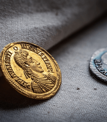 The Patching Hoard was discovered by two metal detectorists, Terry Bromley & Terry Silver, in a field near Patching village in 1997.  A total of 23 gold solidi, 27 silver siliquae, 2 gold rings of exceptional purity and a Roman-pound weight of hack silver were recovered from the site. The hoard is one of the last ‘Roman’ coin hoards to be found in Britain, much of it being acquired on the Continent and brought into Sussex at a time when the Western Roman Empire was crumbling and new polities were emerging on either side of the Channel.