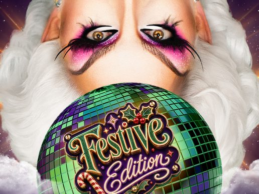 Close-up promotional image featuring a glamorous drag performer with dramatic white hair and bold stage makeup, including sparkling pink and black eye shadow. A large green and purple disco ball fills the centre of the image, displaying the words “Festive Edition” in ornate gold lettering decorated with holly and candy cane motifs. The performer’s eyes peer over the top of the disco ball against a starry purple sky with glowing light flares and clouds, creating a vibrant, festive cabaret atmosphere.