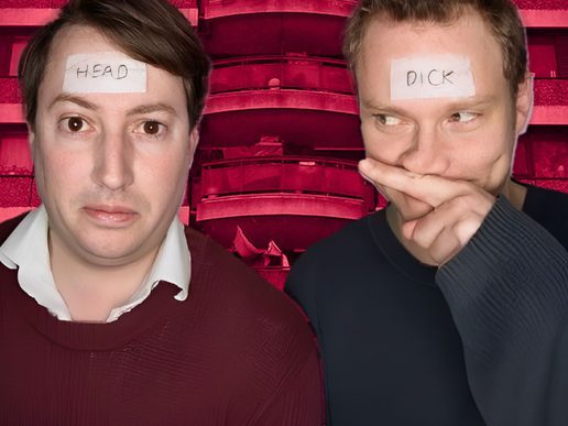 Two men against a red-tinted background, each with a piece of paper stuck to their forehead—one reading “HEAD” and the other reading “DICK”—while one looks ahead blankly and the other glances sideways with a hand partly covering his mouth.